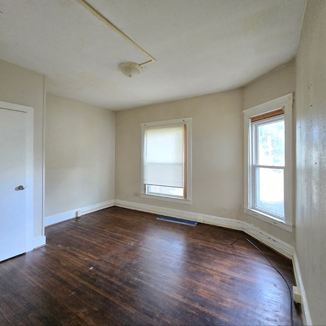 spare room featuring dark hardwood / wood-style floors