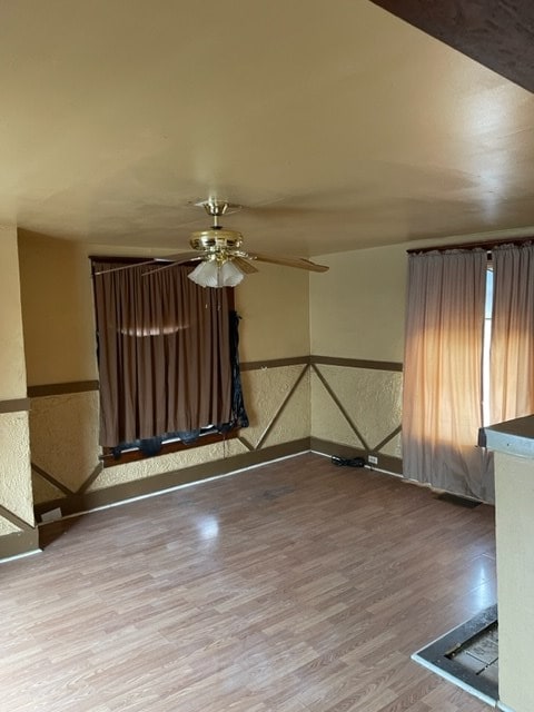 unfurnished room featuring ceiling fan and wood-type flooring