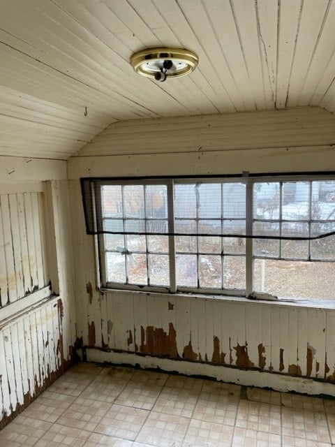 empty room featuring wood ceiling and vaulted ceiling
