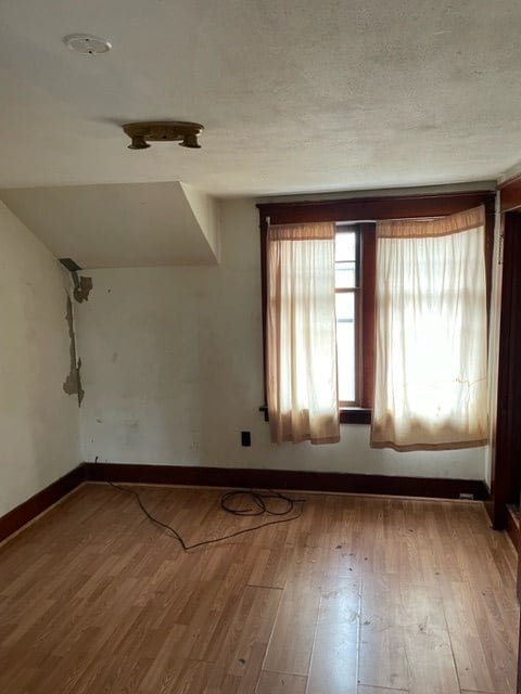 interior space with a textured ceiling and light hardwood / wood-style flooring