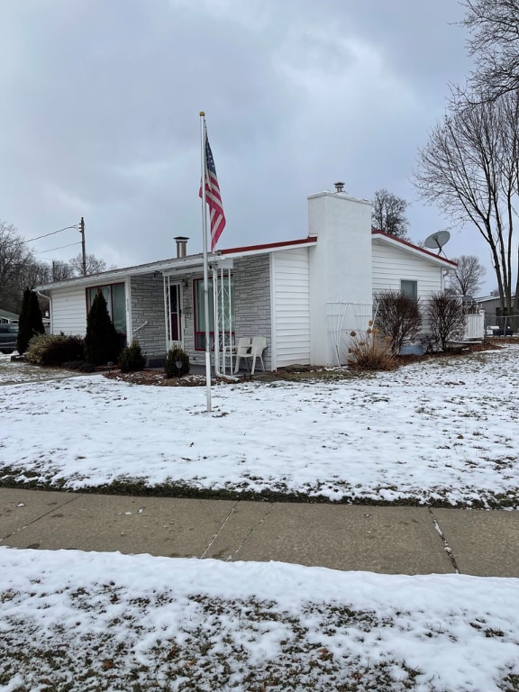 view of snow covered rear of property