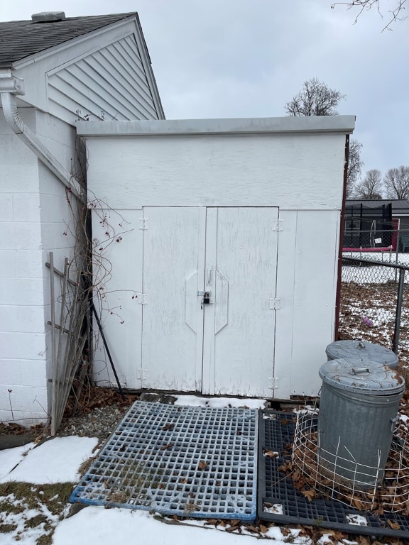 view of shed featuring fence