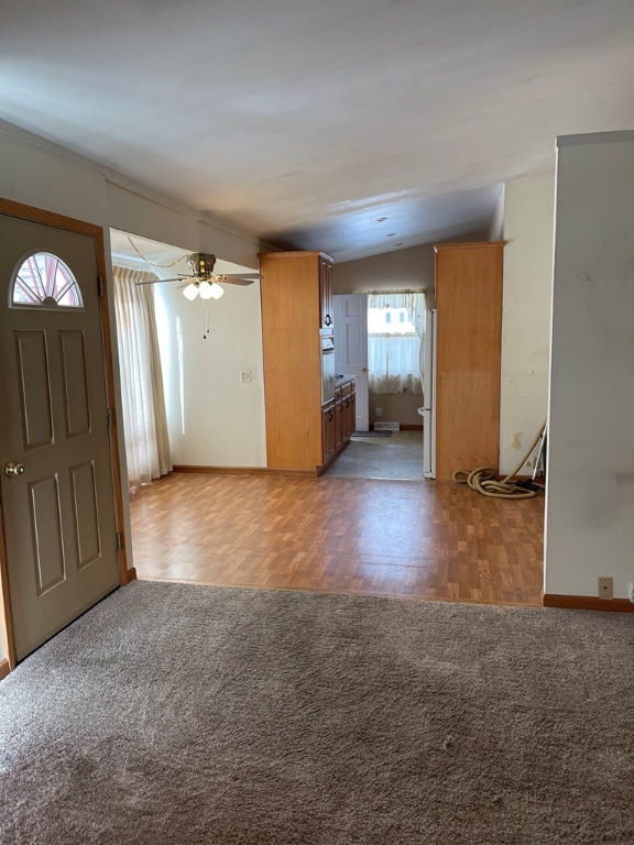 interior space featuring ceiling fan and lofted ceiling