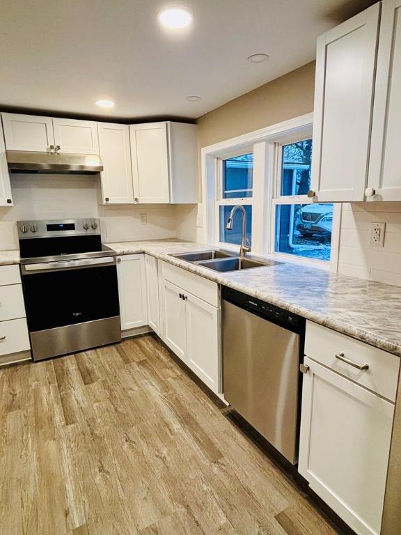 kitchen featuring white cabinetry, stainless steel appliances, and sink