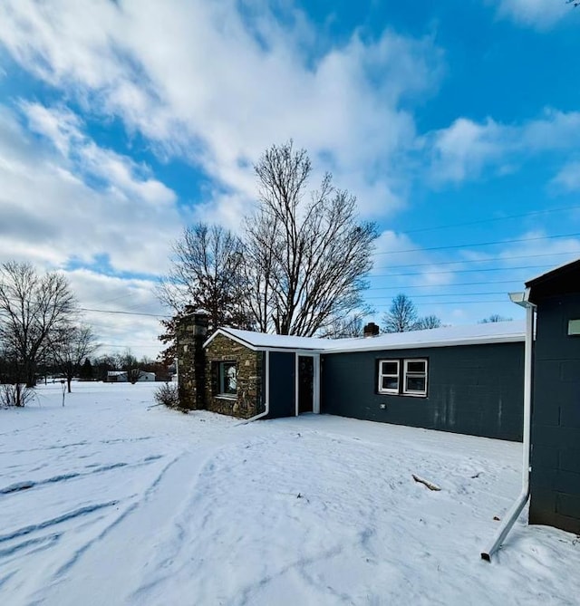 view of snow covered rear of property