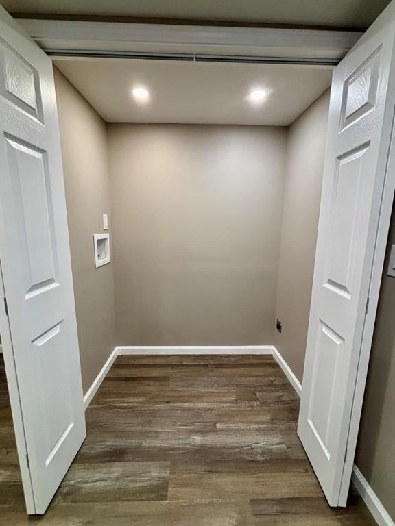 interior space featuring dark hardwood / wood-style floors and washer hookup