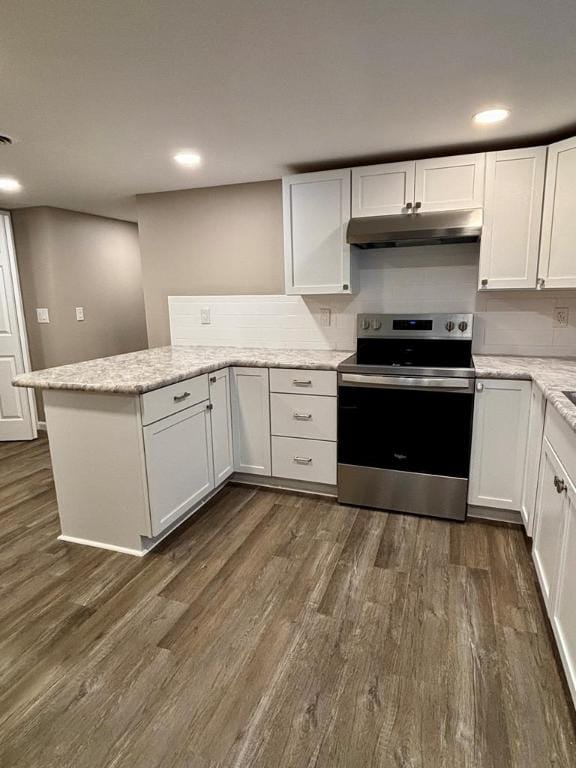 kitchen with dark hardwood / wood-style flooring, electric range, kitchen peninsula, and white cabinets