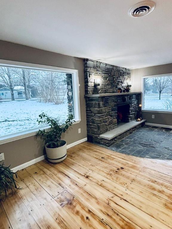 living room featuring hardwood / wood-style flooring and a fireplace