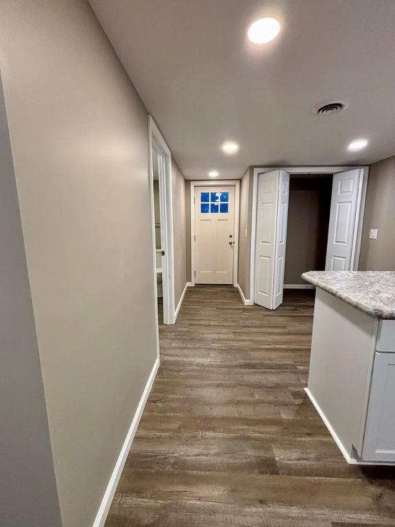 hall with dark wood-type flooring