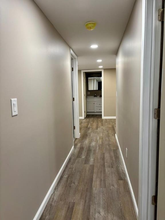 corridor with dark hardwood / wood-style floors