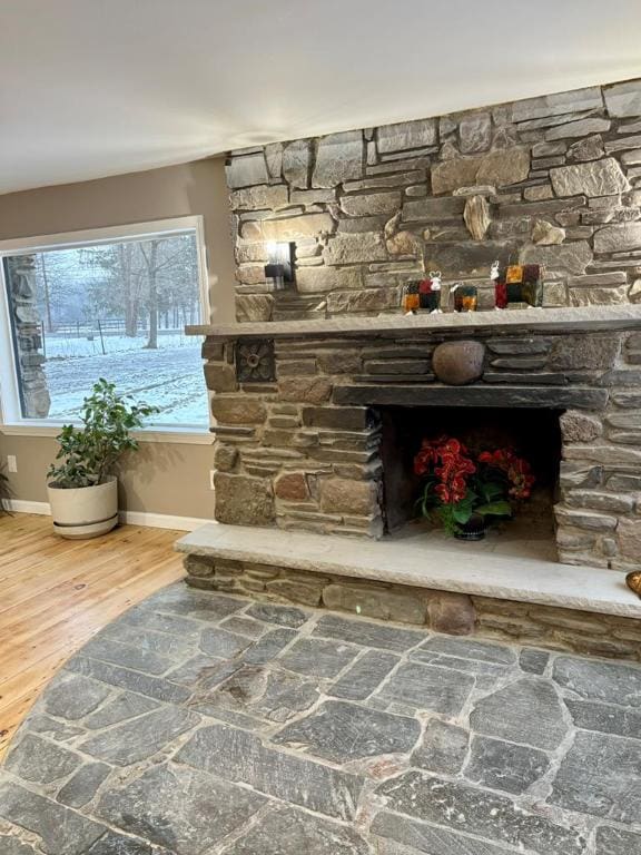 details with a stone fireplace and hardwood / wood-style floors