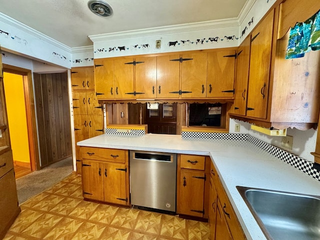 kitchen featuring sink, ornamental molding, stainless steel dishwasher, and light parquet floors