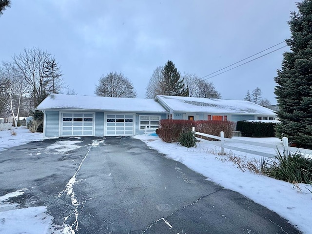 view of snow covered exterior featuring a garage