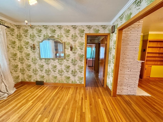 spare room featuring hardwood / wood-style floors and ornamental molding