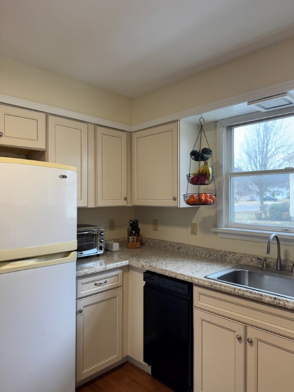 kitchen with white refrigerator, dishwasher, sink, and dark hardwood / wood-style floors