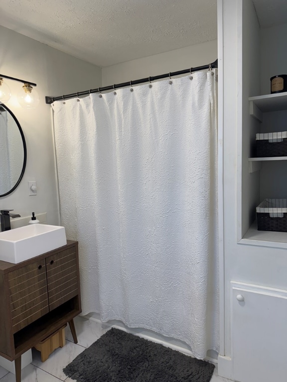 bathroom featuring vanity and a textured ceiling