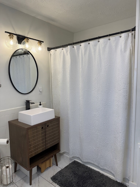 bathroom featuring vanity and a textured ceiling