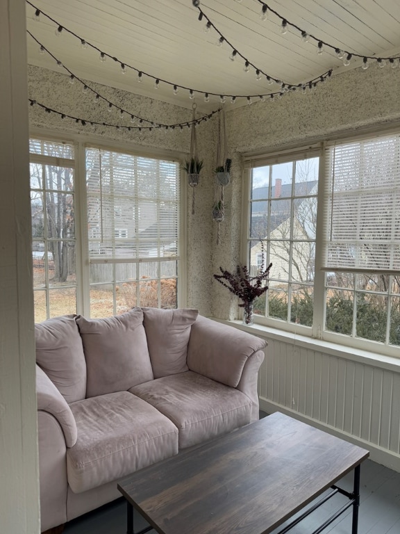 sunroom / solarium featuring track lighting