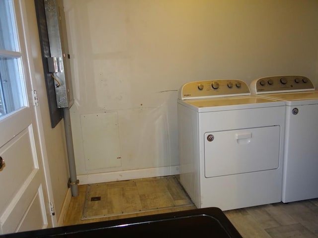 laundry area featuring independent washer and dryer and light wood-type flooring