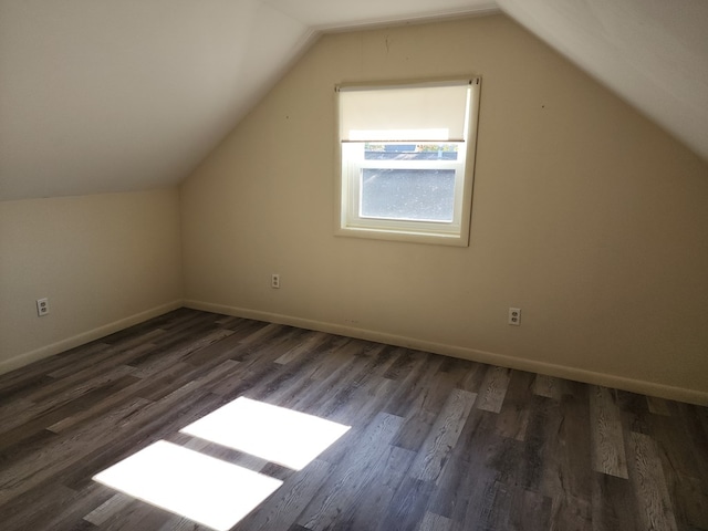 additional living space with lofted ceiling and dark hardwood / wood-style floors