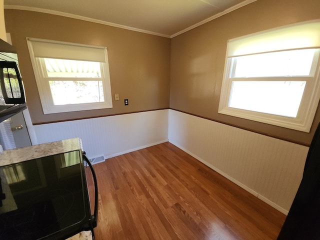 dining area featuring ornamental molding and hardwood / wood-style floors