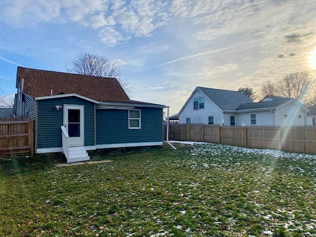 back house at dusk with a yard