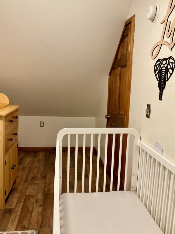 stairs with lofted ceiling and hardwood / wood-style floors