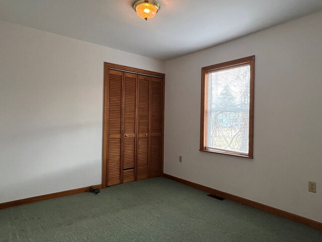 unfurnished bedroom with a closet and carpet flooring