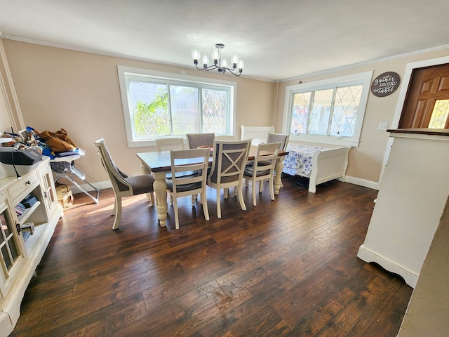 dining space featuring ornamental molding, dark hardwood / wood-style floors, a wealth of natural light, and a notable chandelier