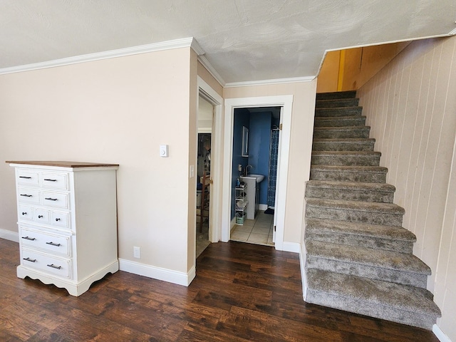 stairway with wood-type flooring and ornamental molding