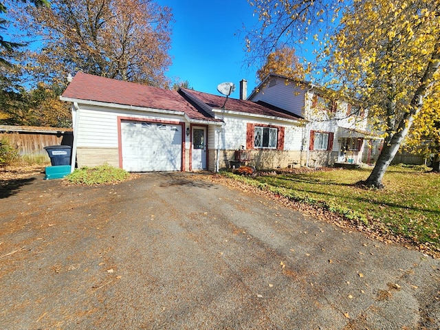 view of front property with a garage and a front lawn