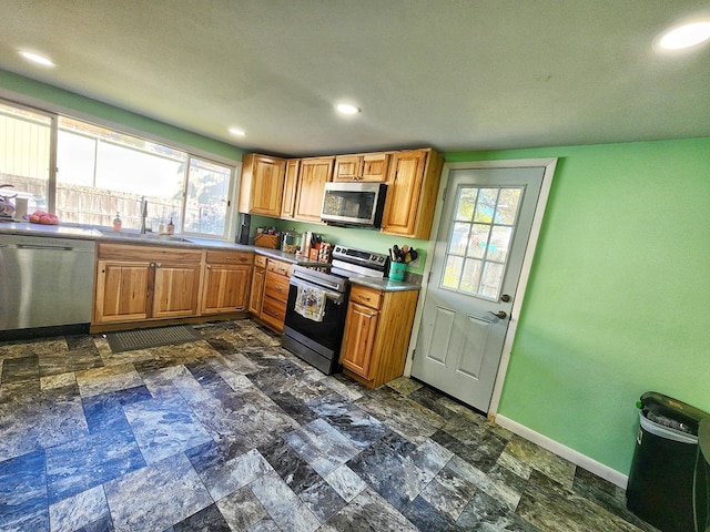 kitchen featuring appliances with stainless steel finishes, sink, and a wealth of natural light