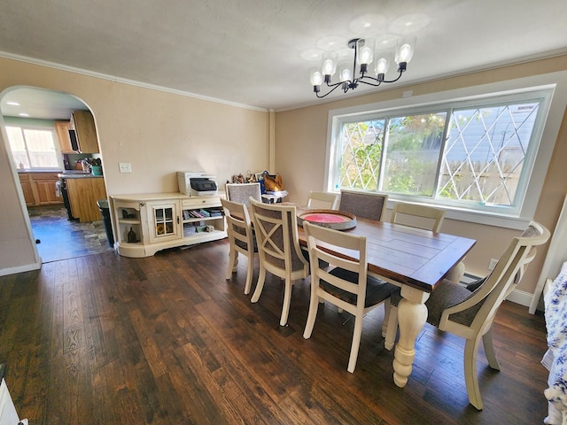 dining area featuring ornamental molding, dark hardwood / wood-style flooring, and a chandelier