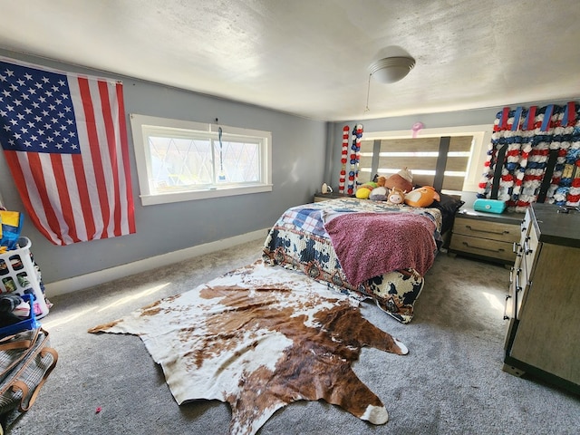 bedroom featuring carpet flooring and a textured ceiling