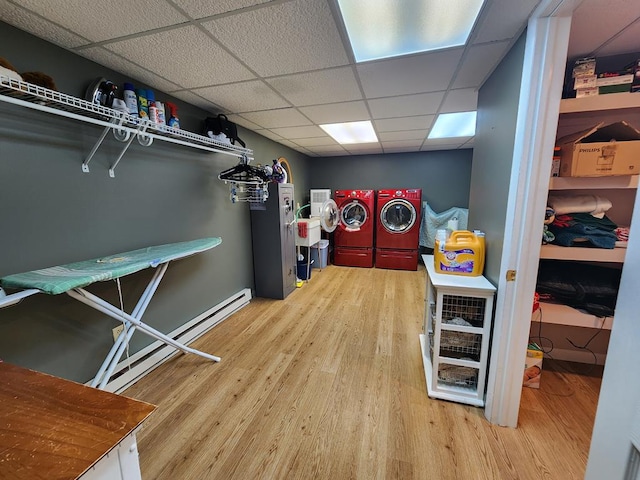 game room featuring hardwood / wood-style flooring, separate washer and dryer, and a drop ceiling