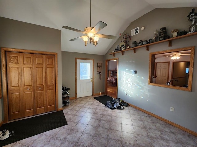 foyer entrance with ceiling fan and vaulted ceiling