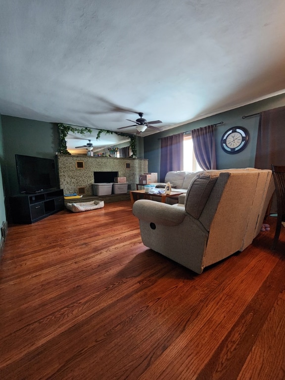 living room featuring hardwood / wood-style flooring, a fireplace, and ceiling fan