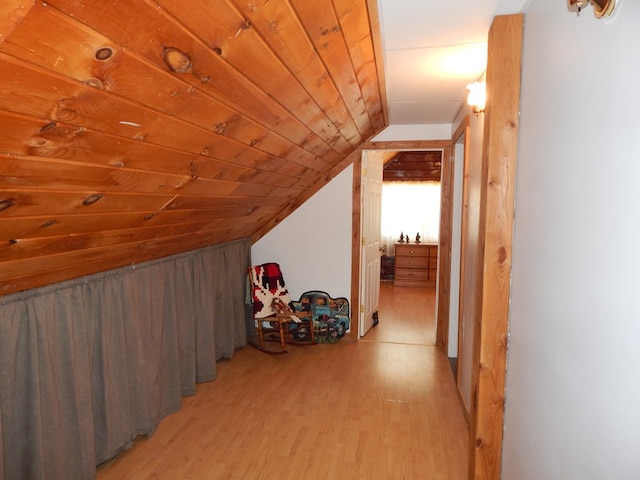 bonus room with vaulted ceiling, light wood-style flooring, and wood ceiling