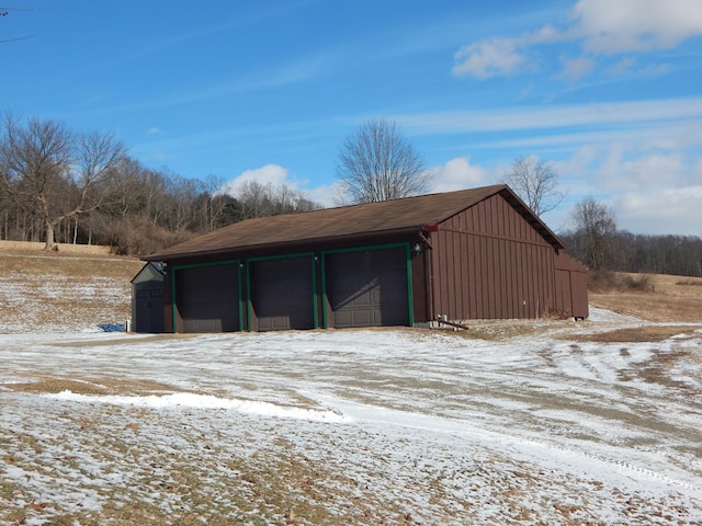 snow covered garage with a garage