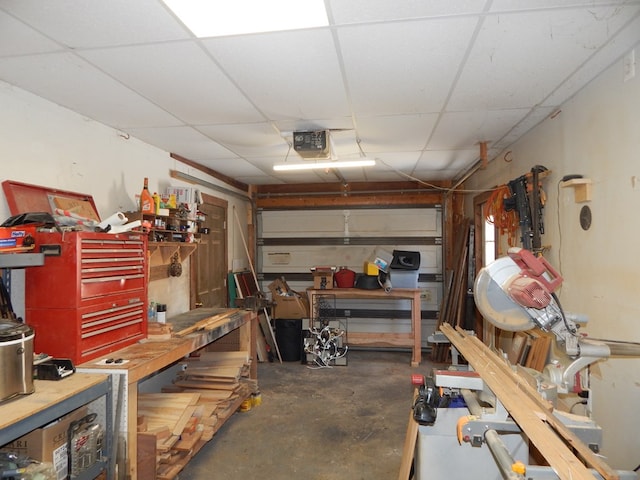 garage with a workshop area and a garage door opener