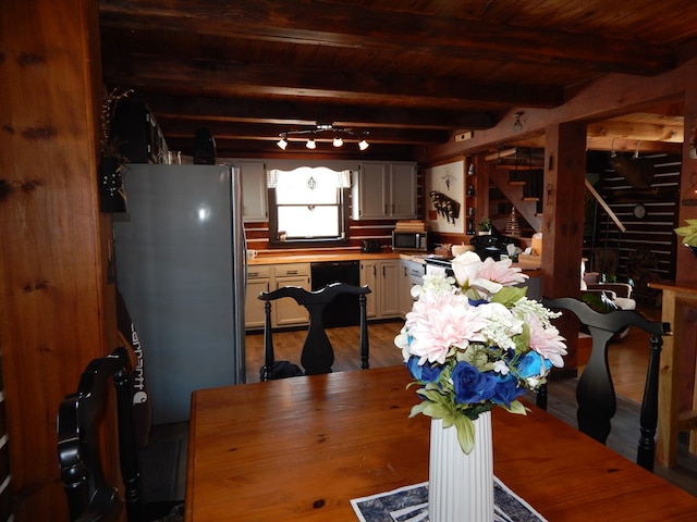 dining area with beam ceiling, wood ceiling, wood finished floors, and stairs