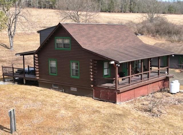 view of front of house with log siding and covered porch