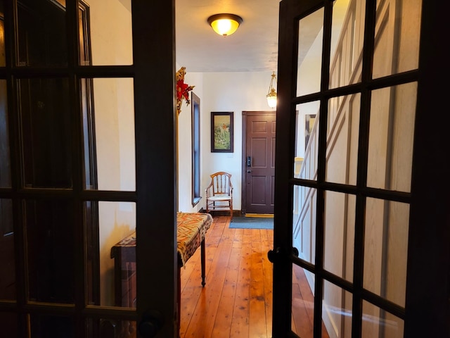 corridor featuring french doors and wood-type flooring