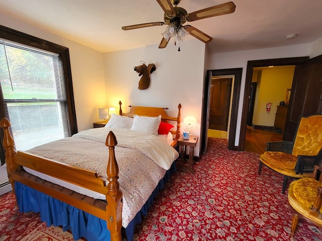 bedroom featuring dark colored carpet and ceiling fan