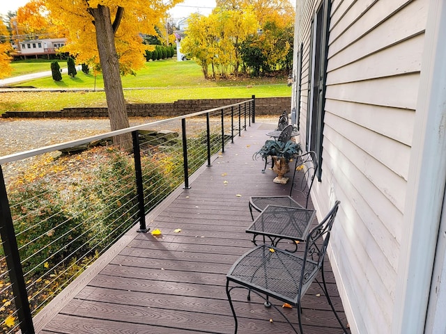 wooden deck with a lawn