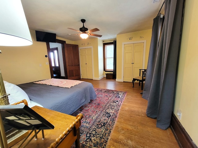 bedroom with ceiling fan, light wood-style flooring, and baseboards