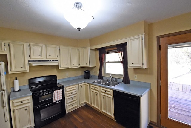 kitchen with dark wood-type flooring, sink, and black appliances