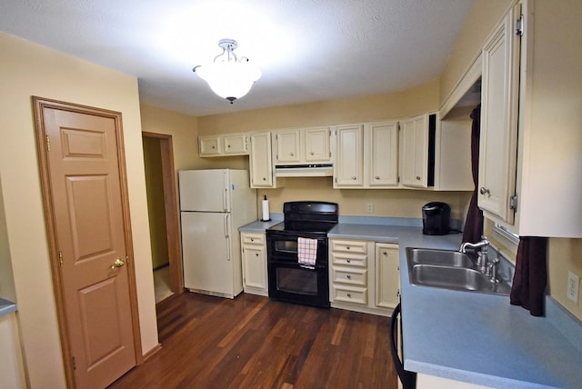 kitchen featuring sink, dark hardwood / wood-style floors, white refrigerator, white cabinets, and range with two ovens