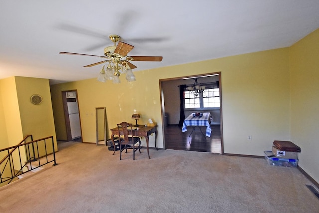 dining space with light colored carpet and ceiling fan