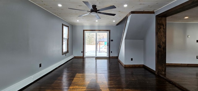 empty room featuring ceiling fan, a baseboard heating unit, wooden ceiling, and dark hardwood / wood-style flooring